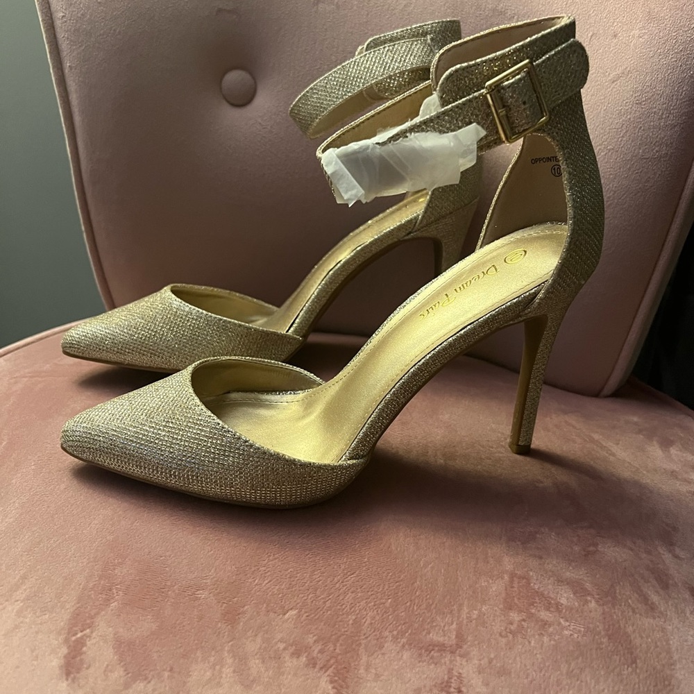 Never worn. Still has protective paper on them. Gold glitter high heels